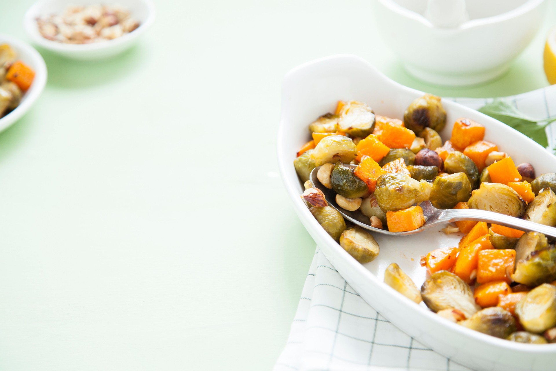 Brussel sprouts and butternut squash with hazelnuts baked in oven.